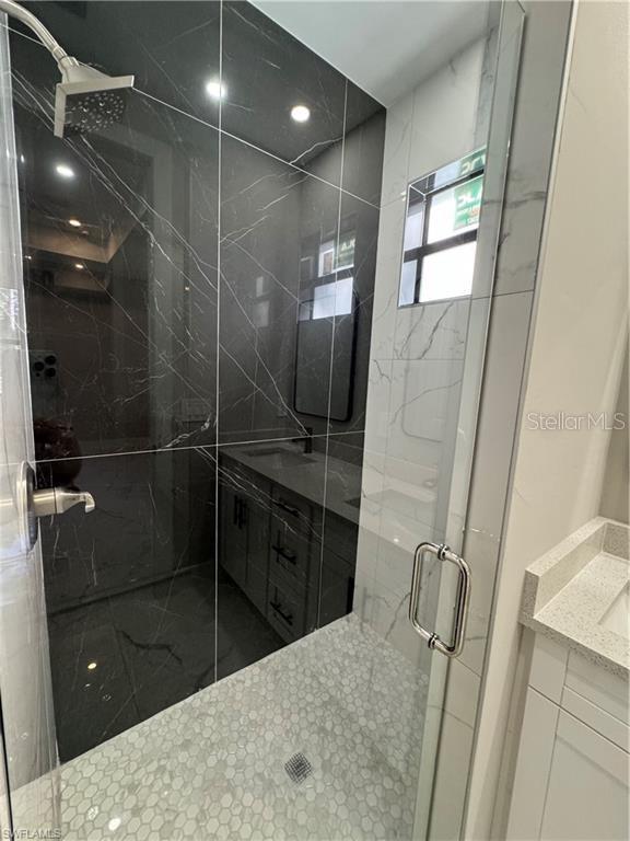 3003 18th St W, Lehigh Acres, FL 33971 - full bath featuring vanity and a marble finish shower