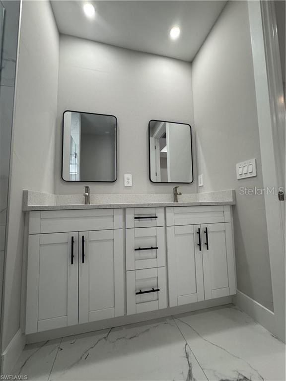 3003 18th St W, Lehigh Acres, FL 33971 - bathroom with marble finish floors, double vanity, and recessed lighting