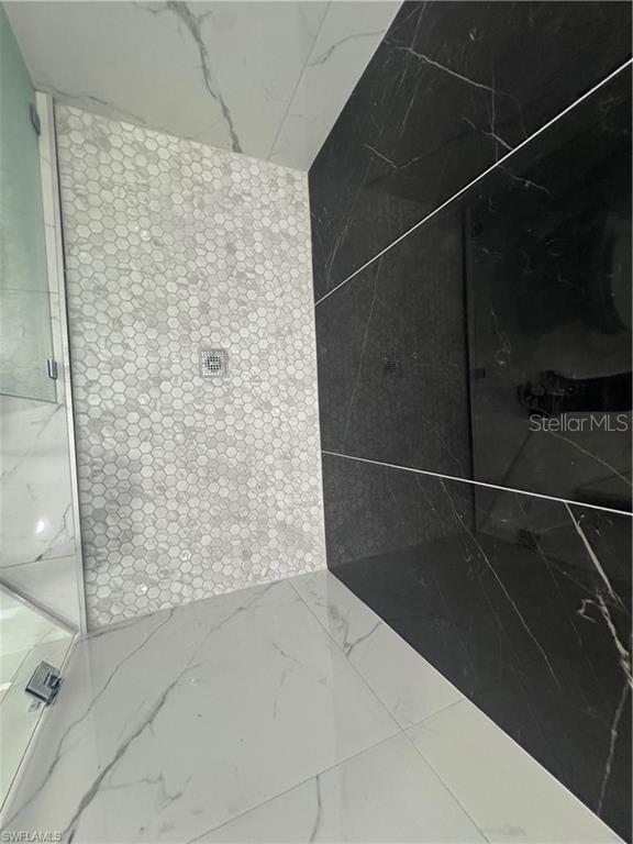 3003 18th St W, Lehigh Acres, FL 33971 - full bath with a marble finish shower and marble finish flooring