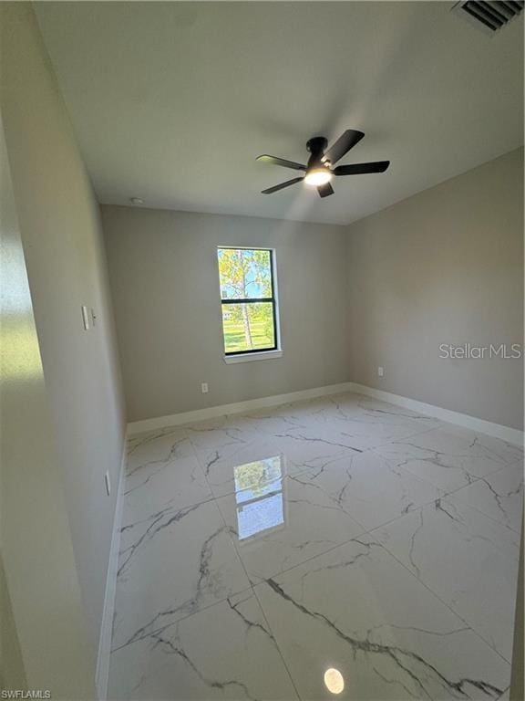3003 18th St W, Lehigh Acres, FL 33971 - spare room featuring marble look tiles and ceiling fan