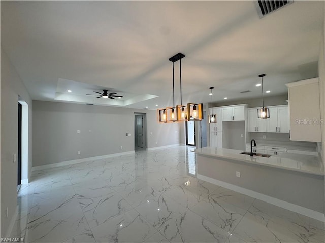 3003 18th St W, Lehigh Acres, FL 33971 - kitchen with a ceiling fan, recessed lighting, white cabinets, light countertops, and pendant lighting