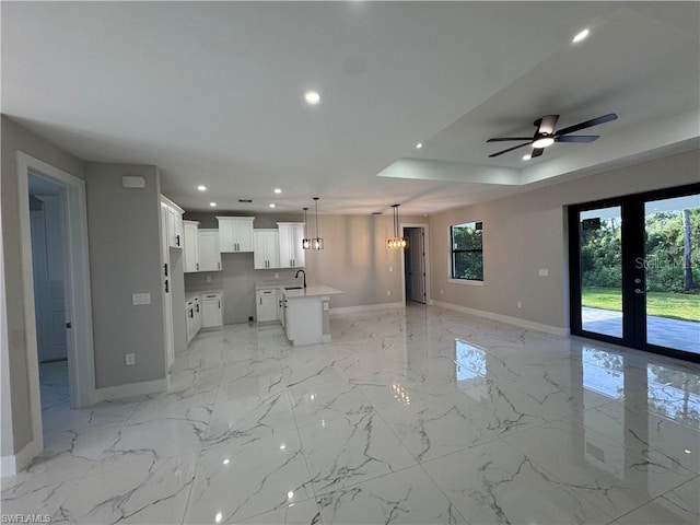 3003 18th St W, Lehigh Acres, FL 33971 - unfurnished living room with plenty of natural light, recessed lighting, light marble finish floors, a chandelier, and ceiling fan