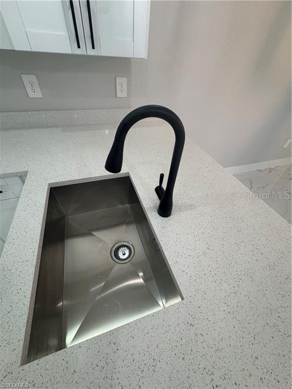 3003 18th St W, Lehigh Acres, FL 33971 - kitchen view of a sink and white cabinets