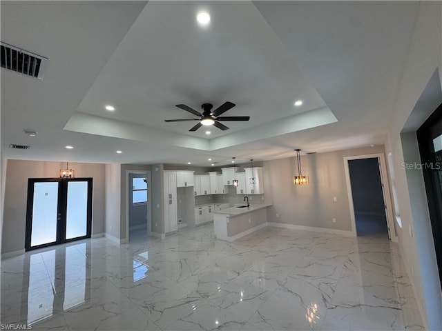 3003 18th St W, Lehigh Acres, FL 33971 - unfurnished living room with a raised ceiling, recessed lighting, ceiling fan, french doors, and light marble finish floors