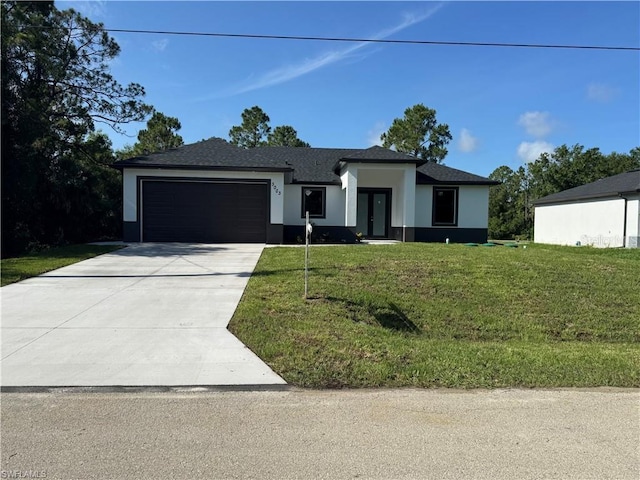 3003 18th St W, Lehigh Acres, FL 33971 - prairie-style home with a garage, stucco siding, french doors, a front lawn, and concrete driveway