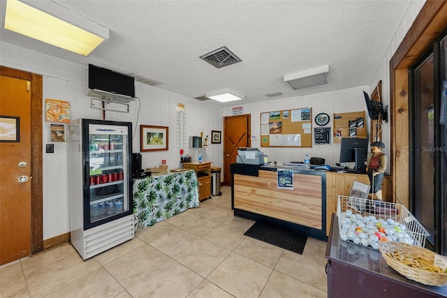 6061 Fairway Ln Unit 1411, Bradenton, FL 34210 - kitchen featuring beverage cooler, light tile patterned flooring, and a textured ceiling