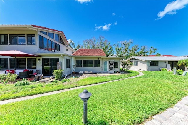 500 Park Blvd S Unit 97, Venice, FL 34285 - back of property featuring a lawn, outdoor lounge area, and a tiled roof