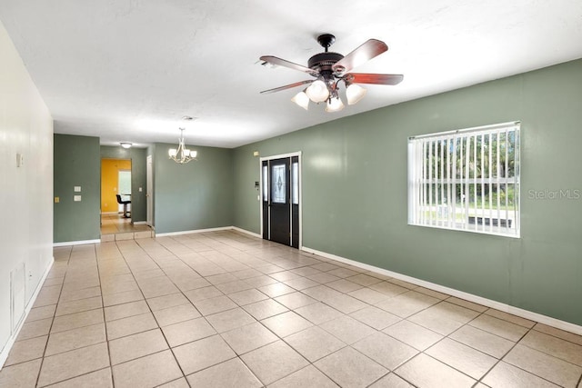 17211 Drayton Ln, Port Charlotte, FL 33948 - empty room with a chandelier, healthy amount of natural light, a ceiling fan, and light tile patterned floors