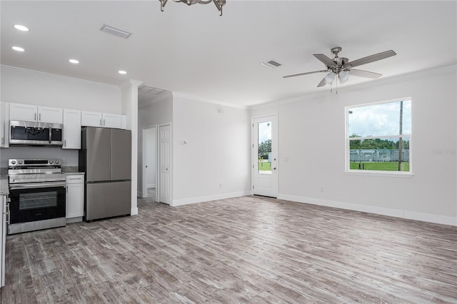 1515 2nd Ave W, Palmetto, FL 34221 - kitchen with stainless steel appliances, light wood-type flooring, crown molding, white cabinetry, and ceiling fan