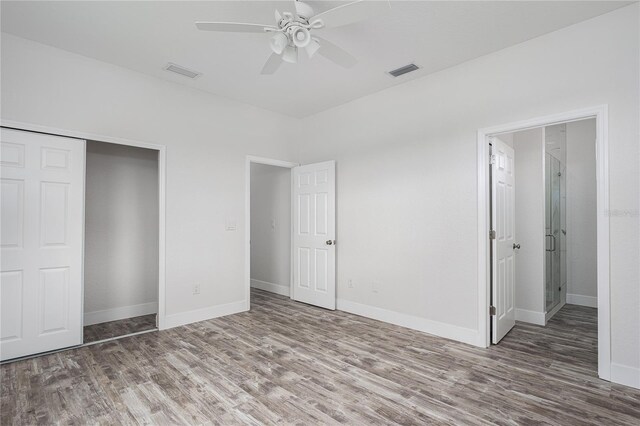 1515 2nd Ave W, Palmetto, FL 34221 - unfurnished bedroom featuring wood finished floors, a closet, and a ceiling fan