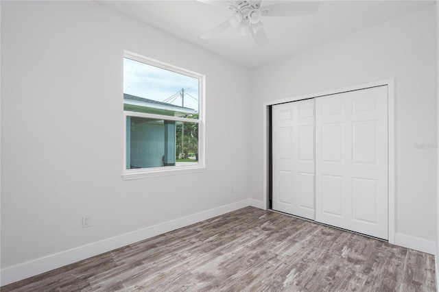 1515 2nd Ave W, Palmetto, FL 34221 - unfurnished bedroom featuring wood finished floors, a closet, and a ceiling fan