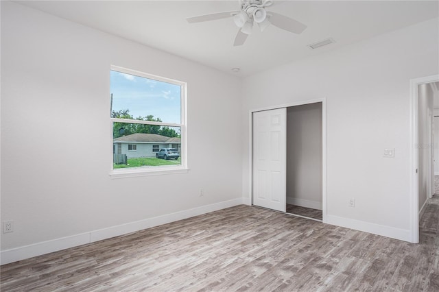 1515 2nd Ave W, Palmetto, FL 34221 - unfurnished bedroom featuring wood finished floors, a closet, and a ceiling fan