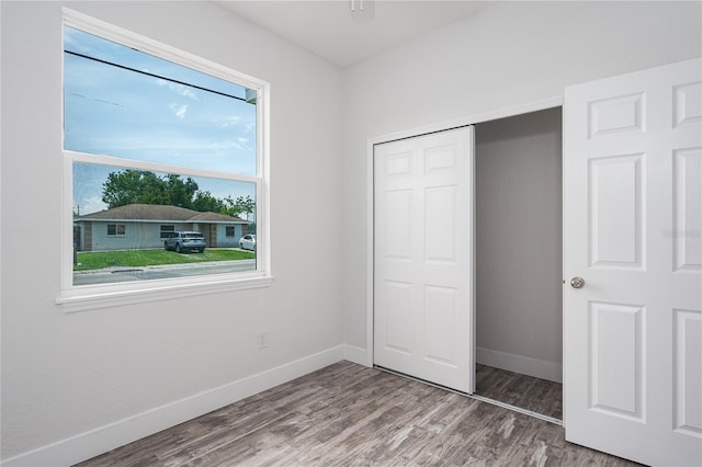 1515 2nd Ave W, Palmetto, FL 34221 - unfurnished bedroom featuring wood finished floors and a closet