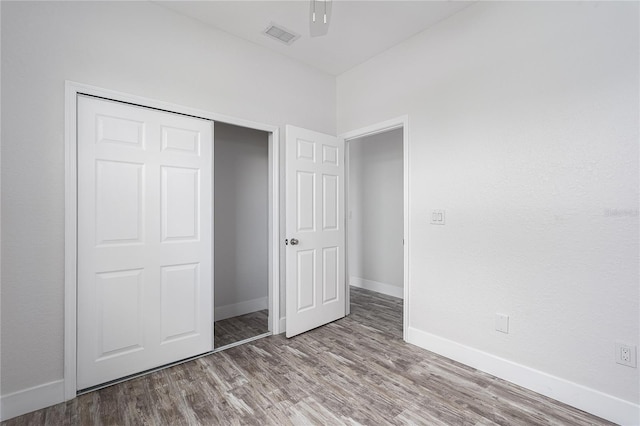 1515 2nd Ave W, Palmetto, FL 34221 - unfurnished bedroom featuring wood finished floors and a closet