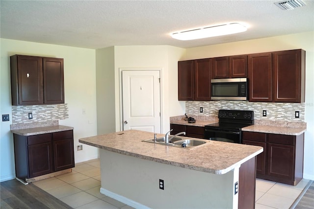 10019 Geese Trail Cir, Sun City Center, FL 33573 - kitchen featuring black electric range oven, stainless steel microwave, tasteful backsplash, dark brown cabinets, and a textured ceiling