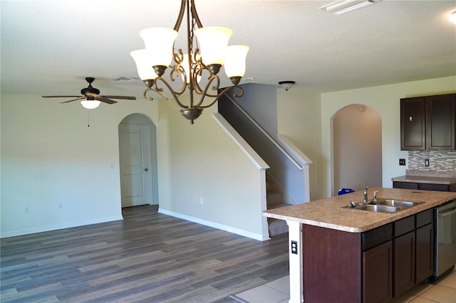 10019 Geese Trail Cir, Sun City Center, FL 33573 - kitchen featuring arched walkways, open floor plan, light countertops, ceiling fan, and a kitchen island with sink