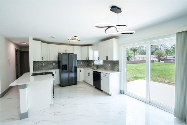 211 22nd Street Ct NE, Bradenton, FL 34208 - kitchen featuring black appliances, a peninsula, tasteful backsplash, light countertops, and white cabinetry