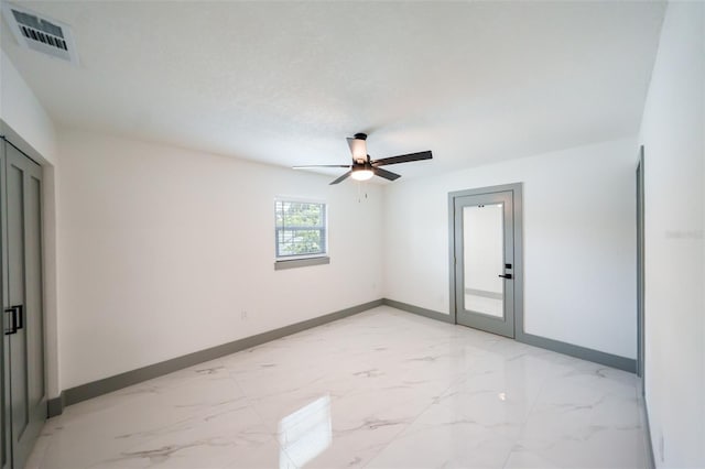 211 22nd Street Ct NE, Bradenton, FL 34208 - unfurnished room with light marble finish flooring and a ceiling fan