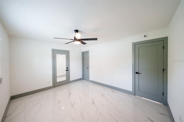 211 22nd Street Ct NE, Bradenton, FL 34208 - unfurnished room with light marble finish flooring, a ceiling fan, and french doors
