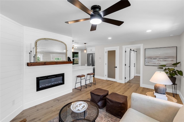 4041 Linwood St, Sarasota, FL 34232 - living area with a glass covered fireplace, light wood-type flooring, ceiling fan, and recessed lighting