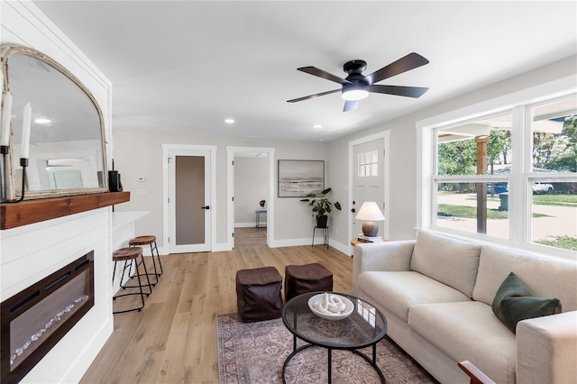 4041 Linwood St, Sarasota, FL 34232 - living room featuring light wood finished floors, a ceiling fan, recessed lighting, and a glass covered fireplace