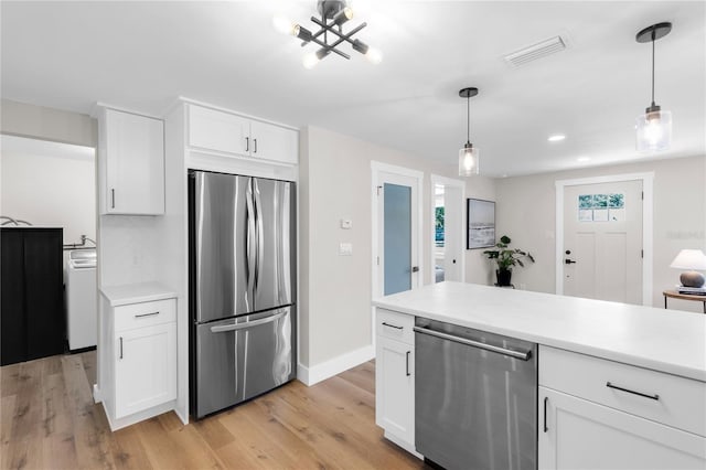4041 Linwood St, Sarasota, FL 34232 - kitchen featuring appliances with stainless steel finishes, light countertops, white cabinetry, light wood-style floors, and recessed lighting