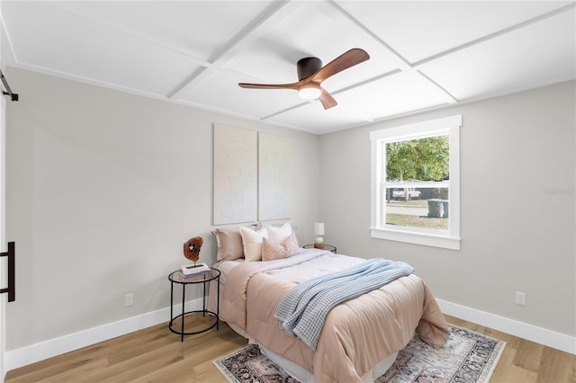 4041 Linwood St, Sarasota, FL 34232 - bedroom with coffered ceiling, light wood-type flooring, a barn door, and ceiling fan