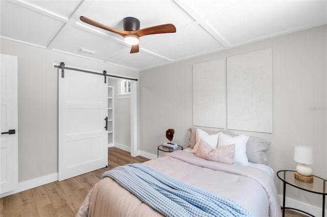 4041 Linwood St, Sarasota, FL 34232 - bedroom with a barn door, wood finished floors, and ceiling fan