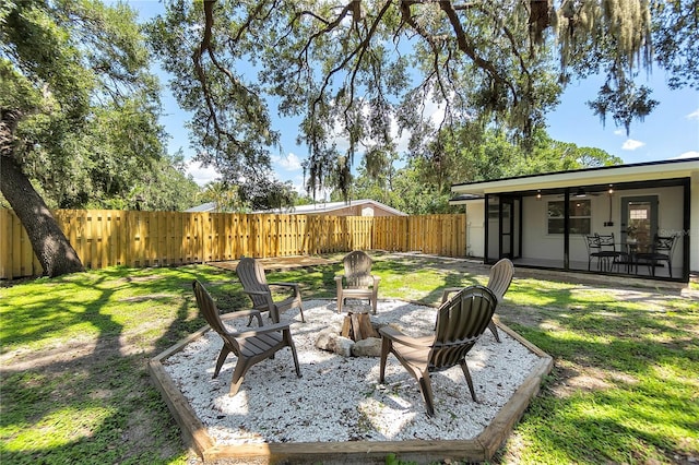 4041 Linwood St, Sarasota, FL 34232 - fenced backyard featuring an outdoor fire pit and a patio