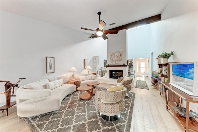 6111 Courtside Dr Unit 61, Bradenton, FL 34210 - living area with ceiling fan, light wood-style flooring, a large fireplace, and high vaulted ceiling