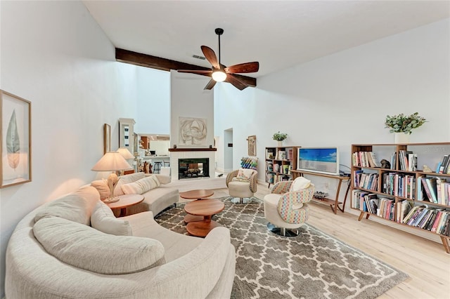 6111 Courtside Dr Unit 61, Bradenton, FL 34210 - living area with a ceiling fan, wood finished floors, high vaulted ceiling, and a glass covered fireplace