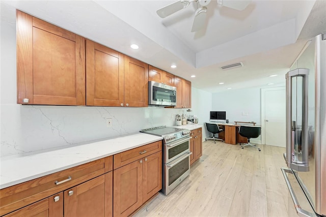 6111 Courtside Dr Unit 61, Bradenton, FL 34210 - kitchen with appliances with stainless steel finishes, light wood-type flooring, brown cabinets, recessed lighting, and tasteful backsplash