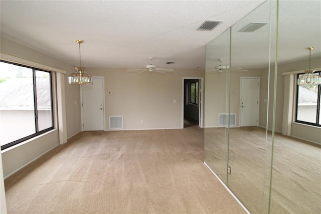 753 Tropical Cir, Sarasota, FL 34242 - unfurnished living room featuring a chandelier, light carpet, and ceiling fan