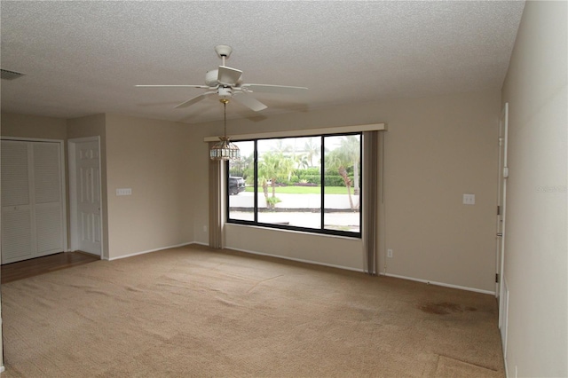 753 Tropical Cir, Sarasota, FL 34242 - unfurnished room with light colored carpet, ceiling fan, and a textured ceiling