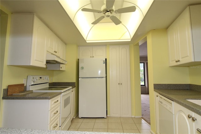 753 Tropical Cir, Sarasota, FL 34242 - kitchen featuring white appliances, under cabinet range hood, light tile patterned floors, and dark countertops