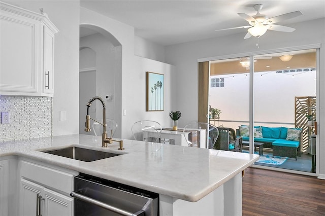 7747 33rd St E, Sarasota, FL 34243 - kitchen featuring dishwasher, decorative backsplash, a ceiling fan, white cabinets, and dark wood-type flooring