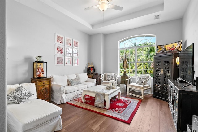7747 33rd St E, Sarasota, FL 34243 - living room featuring a raised ceiling, hardwood / wood-style flooring, and a ceiling fan