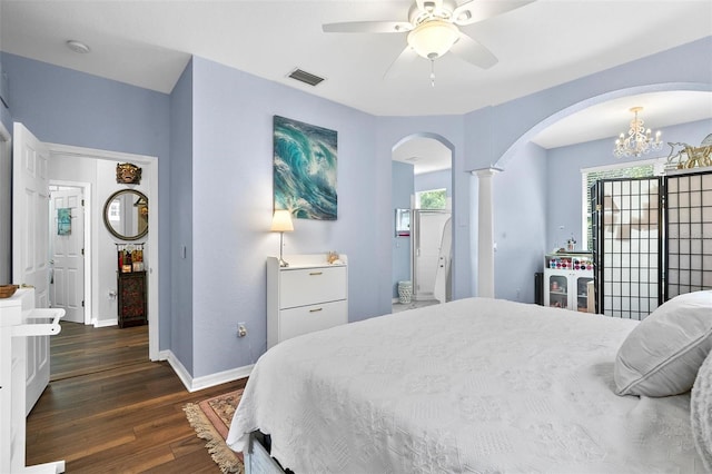7747 33rd St E, Sarasota, FL 34243 - bedroom featuring arched walkways, wood finished floors, decorative columns, a chandelier, and a ceiling fan