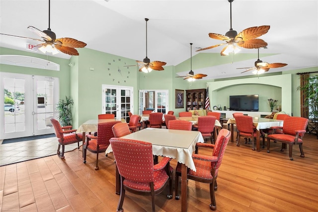 7747 33rd St E, Sarasota, FL 34243 - dining room featuring french doors, light wood-style flooring, and high vaulted ceiling