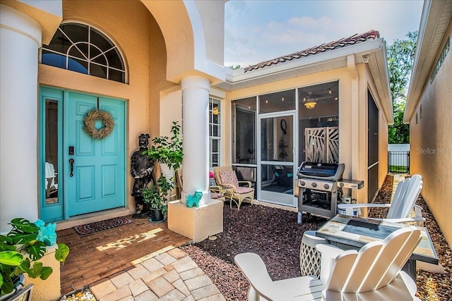 7747 33rd St E, Sarasota, FL 34243 - doorway to property with stucco siding and a tiled roof