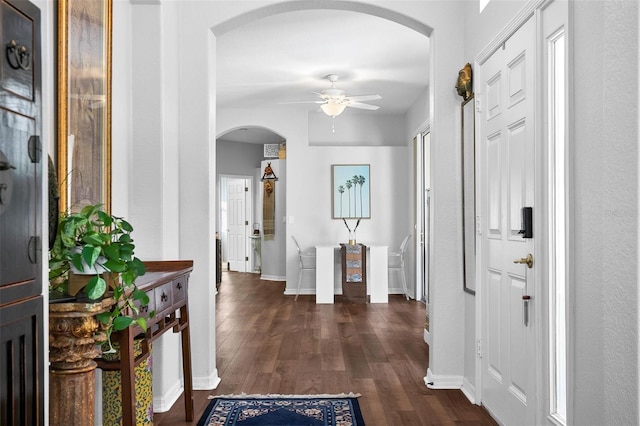 7747 33rd St E, Sarasota, FL 34243 - entryway featuring a ceiling fan, arched walkways, and dark wood-style flooring