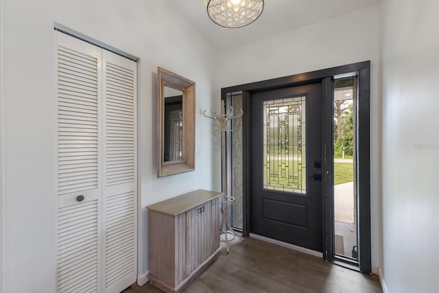 8985 Pohoy Ave, Sarasota, FL 34231 - entryway with dark wood-style flooring and a chandelier