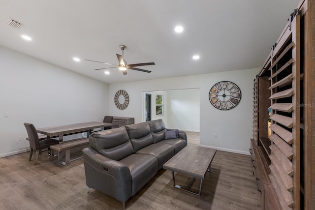 8985 Pohoy Ave, Sarasota, FL 34231 - living area with wood finished floors, a ceiling fan, and recessed lighting