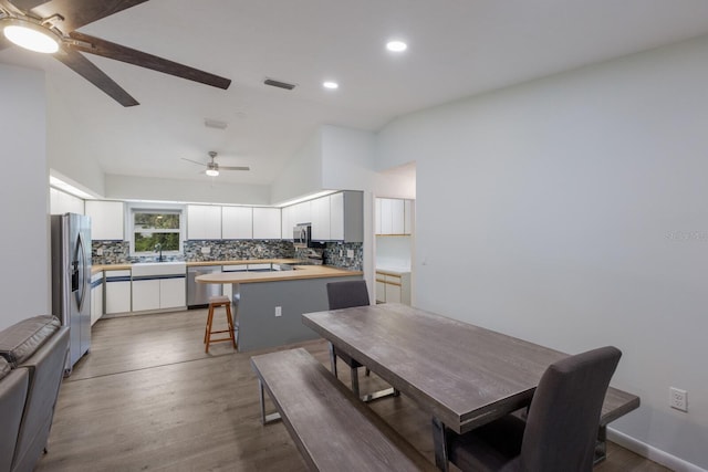 8985 Pohoy Ave, Sarasota, FL 34231 - dining area with ceiling fan, lofted ceiling, wood finished floors, and recessed lighting