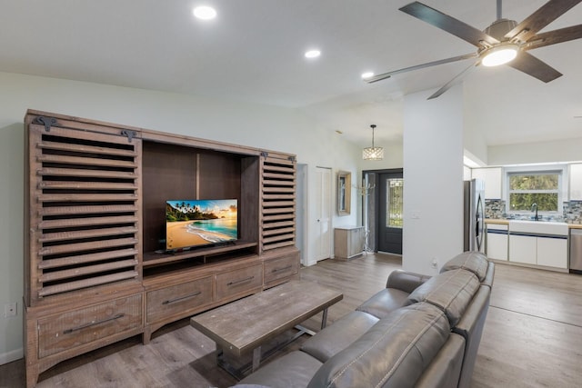 8985 Pohoy Ave, Sarasota, FL 34231 - living area featuring vaulted ceiling, light wood-style floors, ceiling fan, and recessed lighting