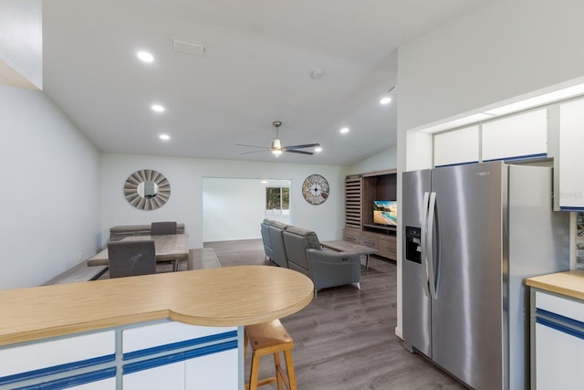 8985 Pohoy Ave, Sarasota, FL 34231 - kitchen with stainless steel refrigerator with ice dispenser, white cabinetry, ceiling fan, recessed lighting, and wood finished floors