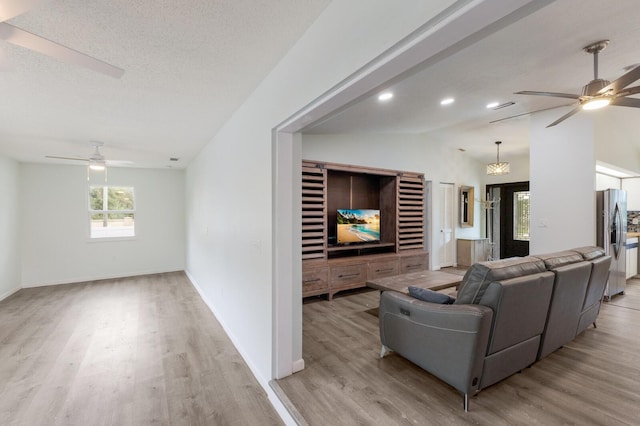 8985 Pohoy Ave, Sarasota, FL 34231 - living area featuring a ceiling fan, light wood-style flooring, and lofted ceiling