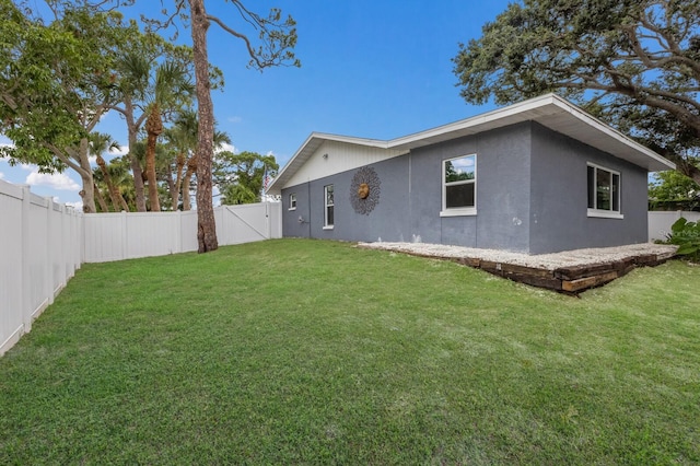 8985 Pohoy Ave, Sarasota, FL 34231 - back of house with a fenced backyard, stucco siding, and a gate