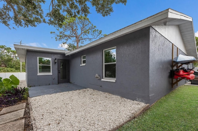 8985 Pohoy Ave, Sarasota, FL 34231 - rear view of house with stucco siding and a patio area