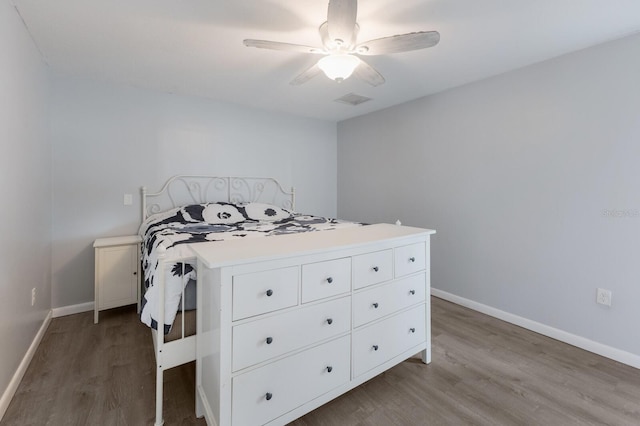 8985 Pohoy Ave, Sarasota, FL 34231 - bedroom with wood finished floors and ceiling fan